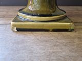 a vase with a flower in it sitting on a table