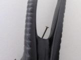 a black sculpture of a horned head on a wall