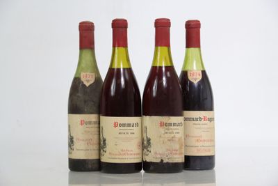 three bottles of wine are lined up in a row on a table