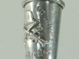 a silver cup on top of a black pen