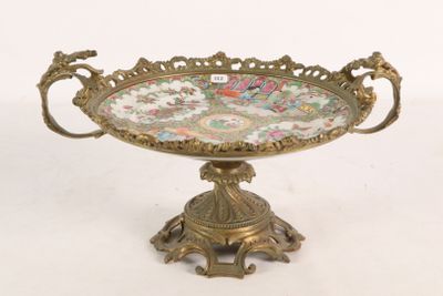 a gold plate with flowers on it on a stand