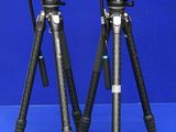 two tripods that are sitting on a blue surface
