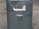 an image of an old gas stove in a parking lot