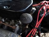 a close up of a car engine with a red wire