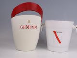 a white bucket with a red handle next to a white bucket with a red handle