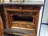 a wooden cabinet with a marble top and a glass door