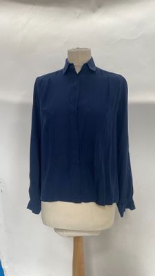 a close up of a mannequin with a blue shirt on it