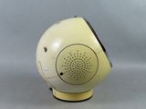 a yellow and black speaker on a stand on a gray background