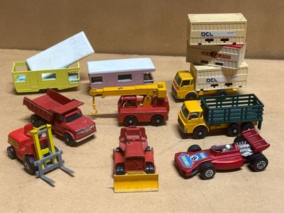 a lot of toy cars and trucks that are on a table