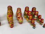 a lot of wooden russian nesting dolls on the table