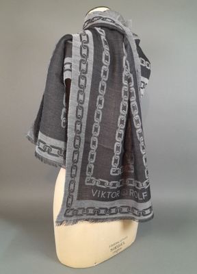 black and grey scarf with chains on it on a mannequin head