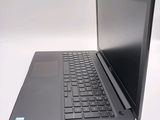 a laptop computer sitting on a table with a keyboard