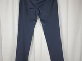 a pair of dark blue pants hanging on a white curtain