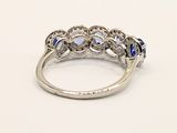 an image of a diamond and sapphire ring on a white background