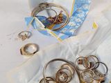a lot of gold rings on a blue and white cloth