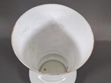 a white bowl with a brown rim sitting on a table