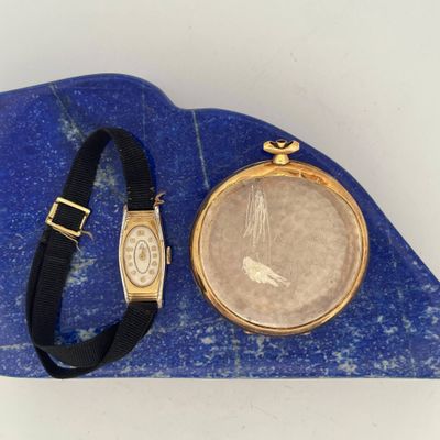 an image of a watch and a bracelet sitting on a blue stone
