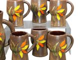 six coffee mugs with orange and yellow flowers painted on them