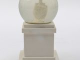 a snow globe sitting on top of a white pedestal