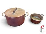 a pot and a bowl of soup on a white surface