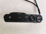 a black camera with a cord attached to it