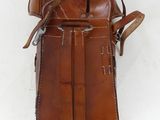 an old brown leather bag with a strap hanging from it ' s side