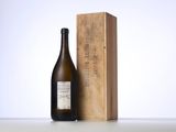 a bottle of wine sitting next to a wooden box