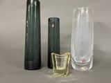 three vases and a glass on the table