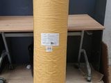 a large roll of yellow paper sitting on the floor
