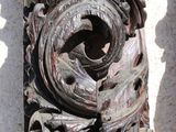 a close up of a carved wood object on a wall