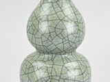 a green vase that has a cracky design on it
