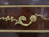 a large wooden table with a gold decoration on it