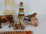a wooden toy set with a toy horse, a toy car, a toy chair, a toy horse, and a wooden toy car