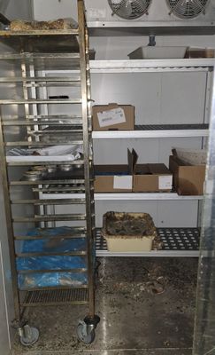 a metal rack with food on it in a kitchen