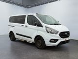 the white van is parked inside of a large white room