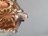 a person holding a silver object in their hand