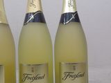 three bottles of sparkling wine sitting on a table next to each other