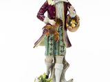 an image of a figurine of a man with a basket of fruit