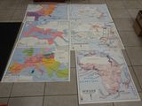 several maps of europe on a tiled floor in a room