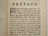 an old book with a black and white image of a face on it