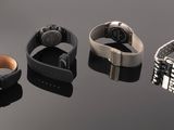 three different watches are shown in a row on a reflective surface