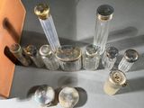 a lot of small glass bottles and spoons on the table