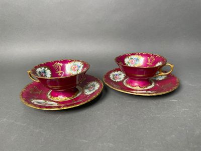 a pair of pink and gold tea cups and saucers
