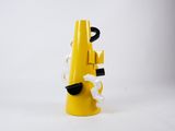 a yellow telephone that is on a white surface