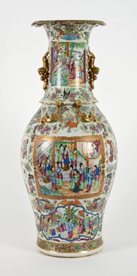 a vase with a painting on it sitting on a table
