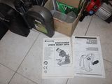 a box of tools sitting on the floor next to a pair of shoes