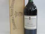 a bottle of wine sitting next to a wooden box