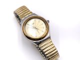 an image of a gold and silver watch on a white surface