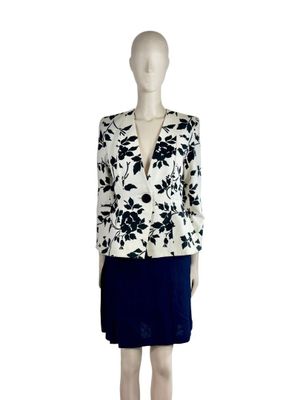 an image of a mannequin wearing a black and white dress and jacket