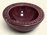 a small brown bowl with writing on it